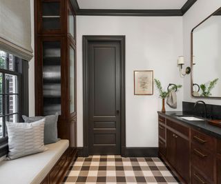 A white and brown bathroom with a woven tile design on the floor