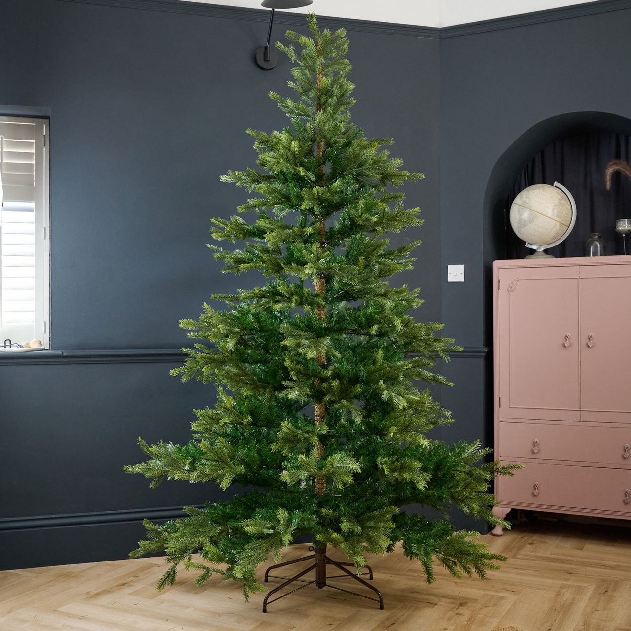 The White Company's 7.5ft Grand Spruce Christmas Tree in a black-painted living room
