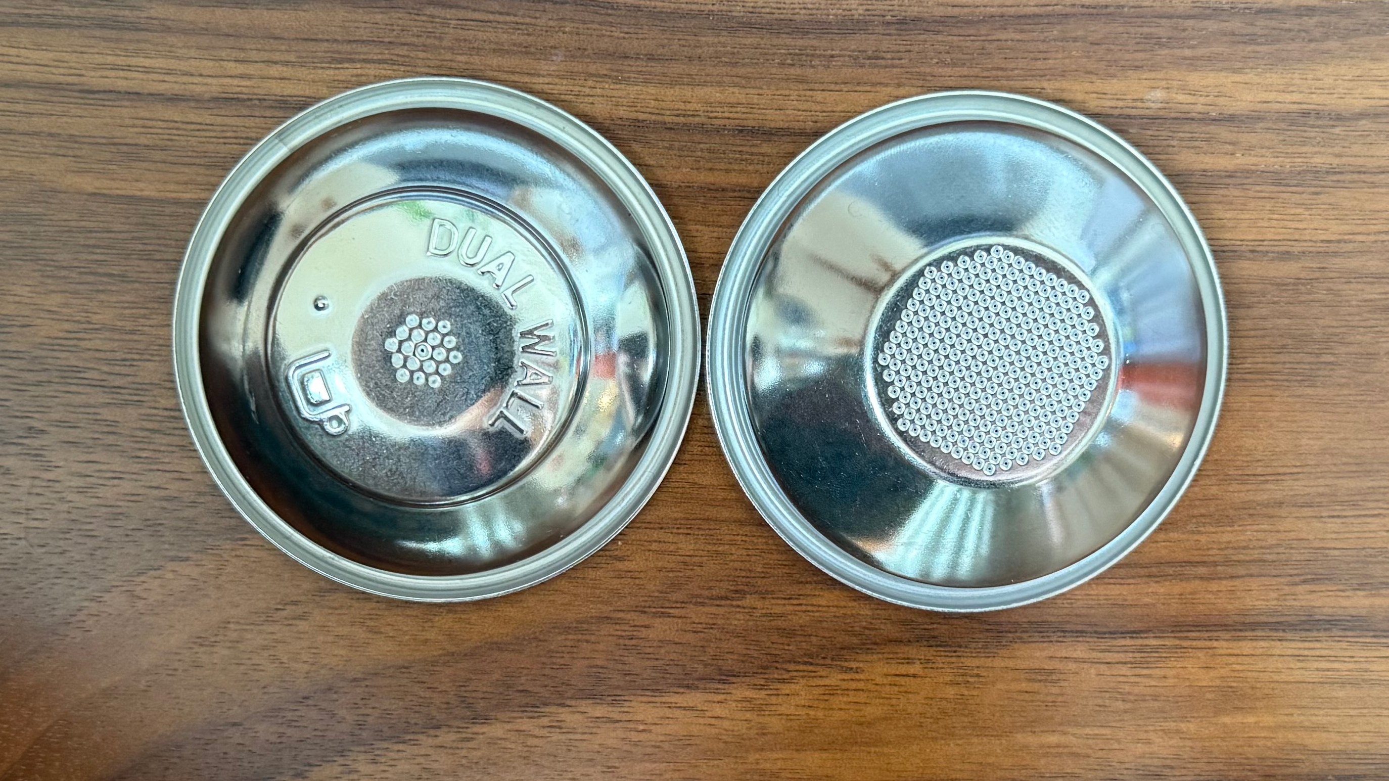 a picture of a dual walled and single walled portafilter from the breville bambino plus machine