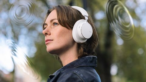 Woman wearing a pair of AKG N9 headphones in white