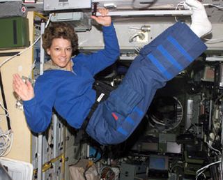 Astronaut Eileen M. Collins, STS-114 commander, waves while floating in the Zvezda Service Module of the International Space Station.