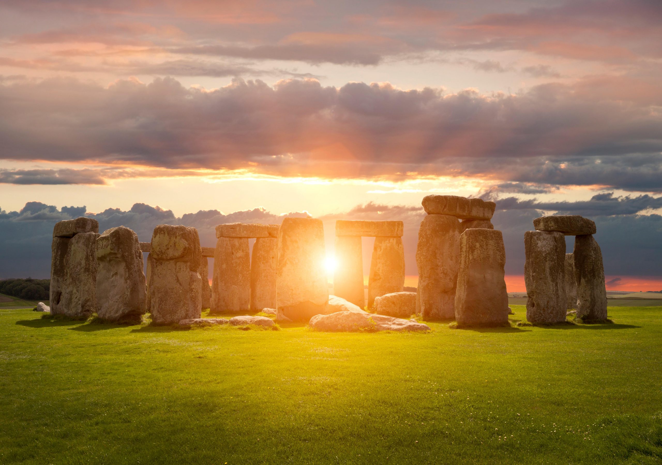 The sun setting over Stonehenge, Wiltshire.