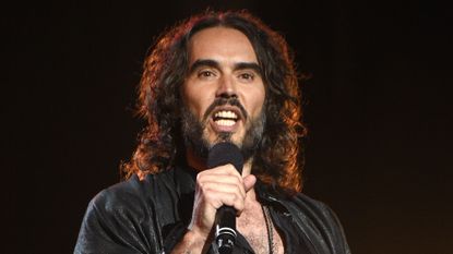 Russell Brand performing on stage