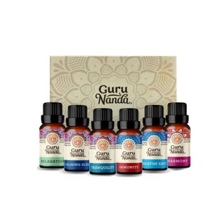 A set of six GuruNanda essential oils with a box