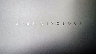 The Asus Vivobook badging on the top cover of the Vivobook 16 Flip convertible laptop.