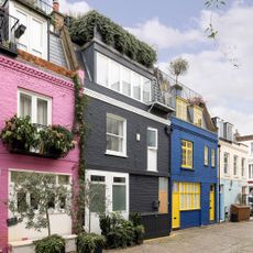 exterior of house with yellow door and green plants