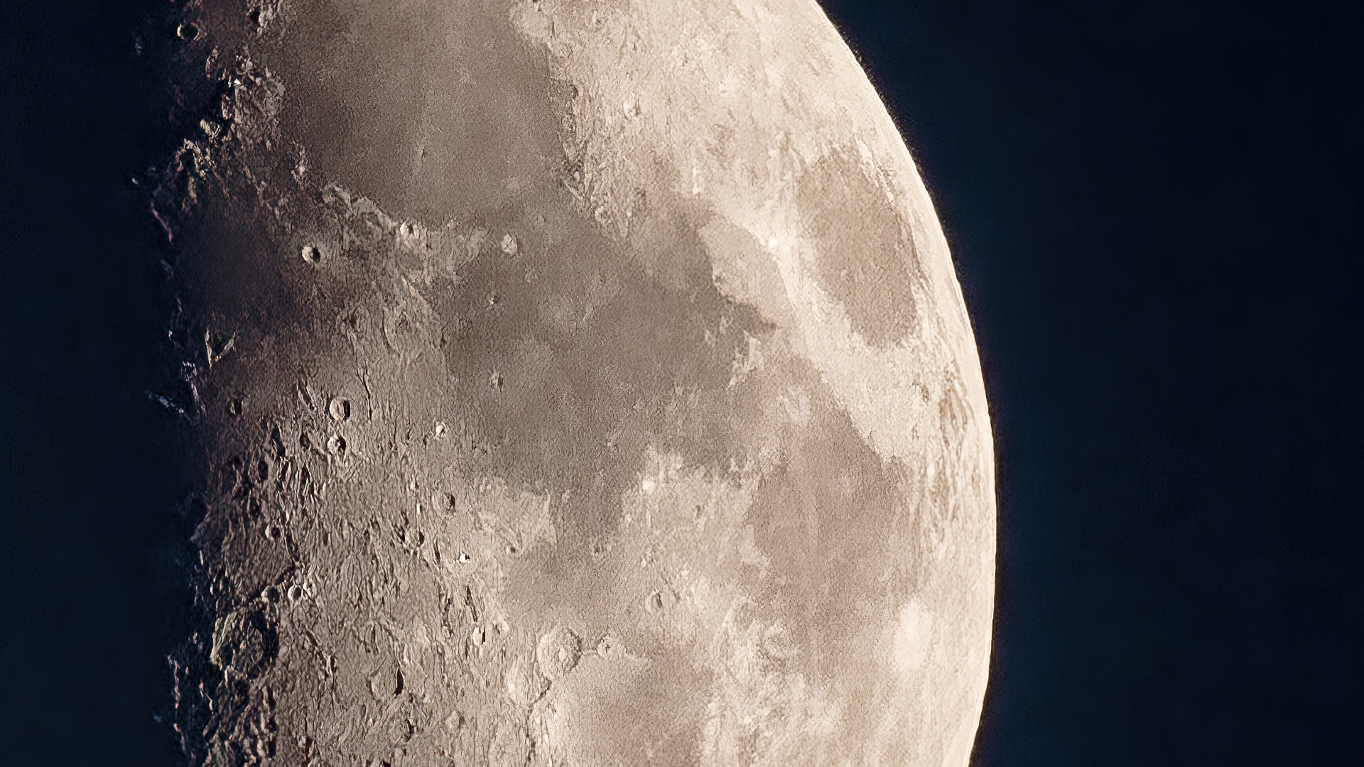 Close up of the moon. The surface of the moon has many craters.