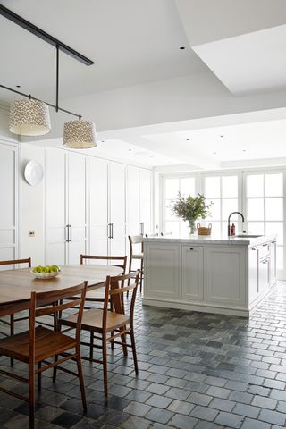 Grey cobbled floor tiles in a kitchen diner