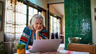 A woman working at a laptop