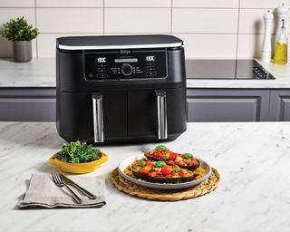 Ninja dual zone air fryer with aubergine dish on kitchen counter