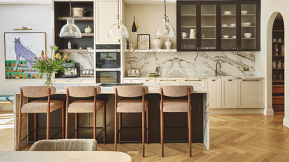 large modern kitchen with an island, bar seating and marble splashback