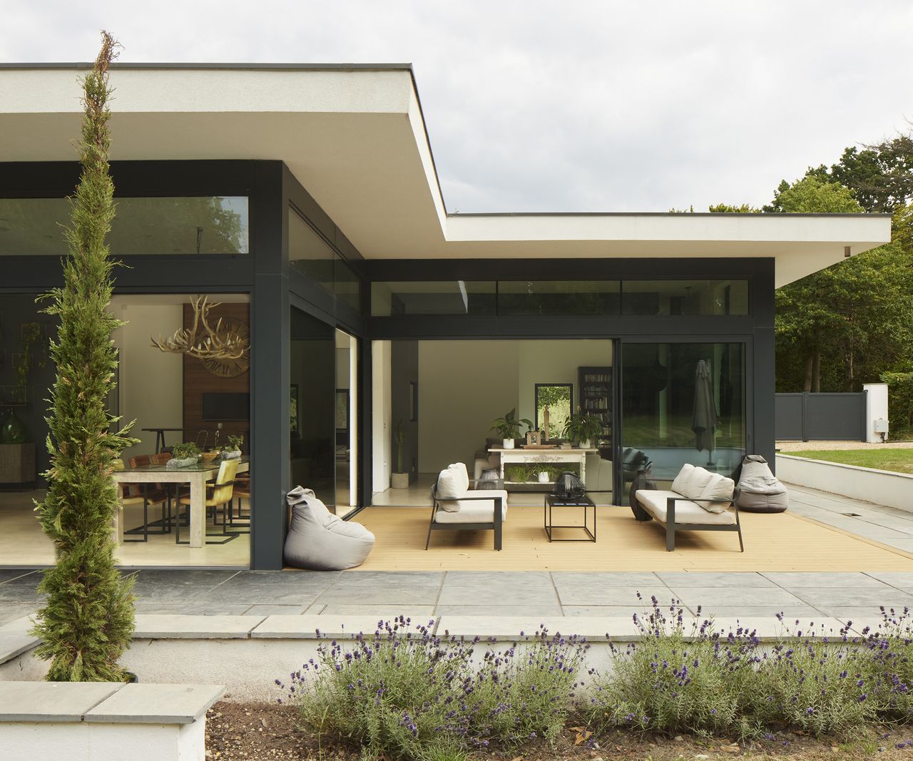 rear view of a contemporary home self build with lawn and outdoor living patio