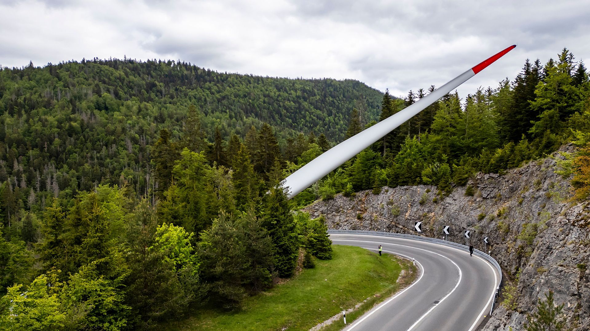
                                A wind turbine blade is transported through the mountains as part of the construction of the Sur Grati wind farm, near Vallorbe, Switzerland
                            