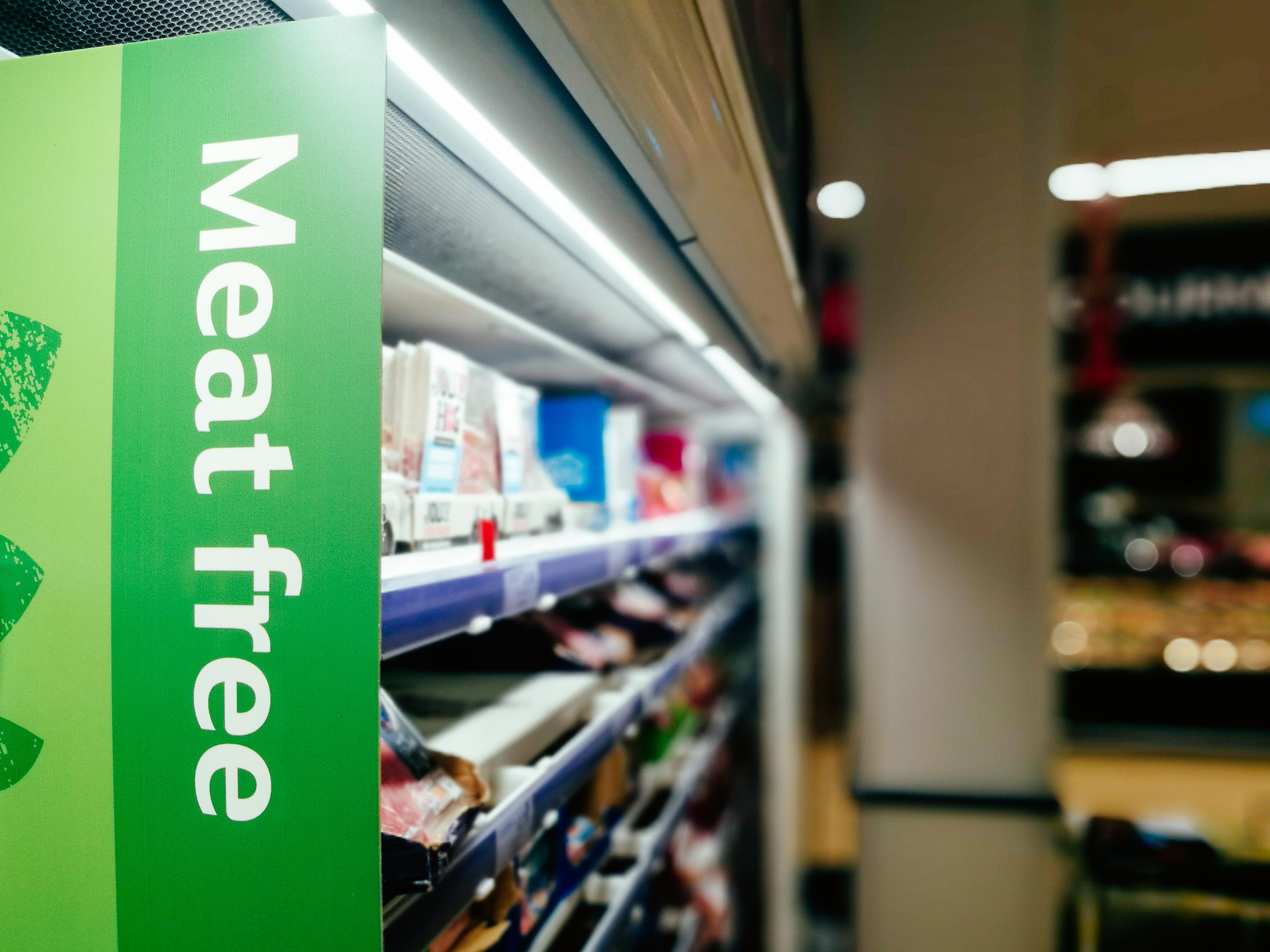  A supermarket isle with a sign saying meat free 