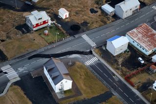 a sinkhole on the road in grindavik, iceland, where a volcano may be about to erupt
