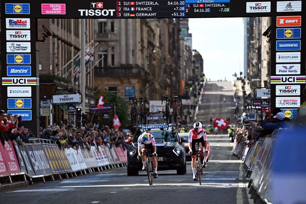 Riders from Switzerland cross the finish line to win gold in the Team Time Trial Mixed Relay road race during the UCI Cycling World Championships in Glasgow Scotland on August 8 2023 Photo by Oli SCARFF AFP Photo by OLI SCARFFAFP via Getty Images