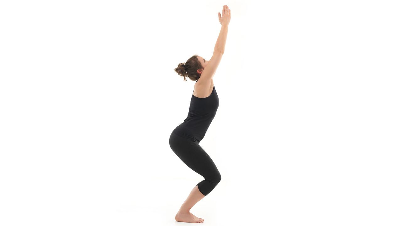 Woman doing Chair Pose in yoga
