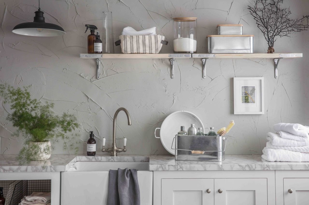 utility room storage with butlers sink and shelves