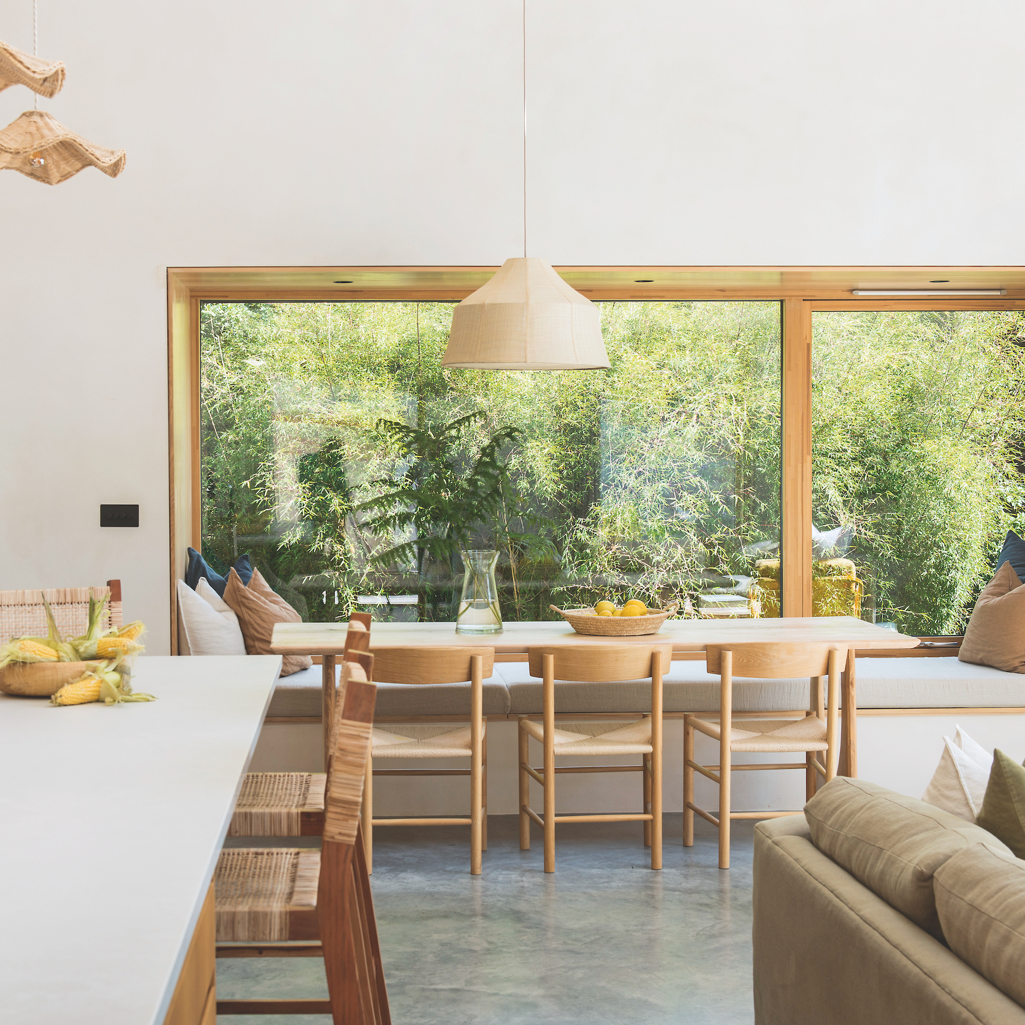 interior of self-build coastal house in cornwall featuring an open-plan living space with a kitchen and dining area with large window
