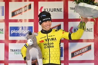 KUURNE BELGIUM FEBRUARY 25 Wout Van Aert of Belgium and Team Visma Lease A Bike celebrates at podium as race winner with donkey trophy during the 76th Kuurne Bruxelles Kuurne 2024 a 1964km one day race from Kortrijk to Kuurne on February 25 2024 in Kuurne Belgium Photo by Luc ClaessenGetty Images