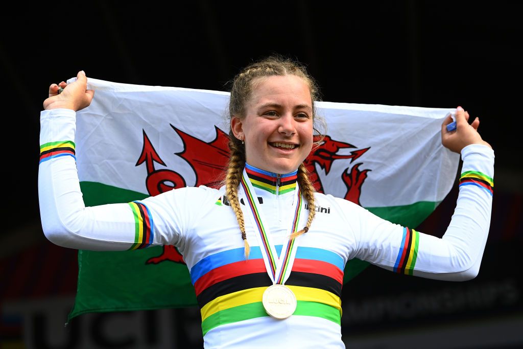 WOLLOGONG AUSTRALIA SEPTEMBER 20 Gold medalist Zoe Backstedt of The United Kingdom celebrates holding the Walles flag during the medal ceremony after the 95th UCI Road World Championships 2022 Women Junior Individual Time Trial a 141km race from Wollongong to Wollongong Wollongong2022 on September 20 2022 in Wollongong Australia Photo by Tim de WaeleGetty Images