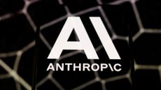 Anthropic logo and branding pictured on a smartphone screen placed on a reflective surface.