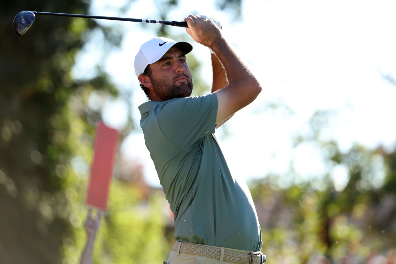 Scottie Scheffler hits a fairway wood