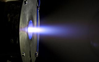 The Helicon Plasma Thruster, developed by the European Space Agency by SENER in Spain, completes a test firing in this image. The thruster, which uses high power radio frequency waves to turn propellant into a plasma, is designed to propel small satellites and maintain large megaconstellations of satellites.