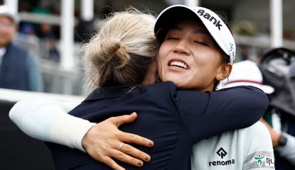 Ko hugs her playing partner whilst celebrating her win