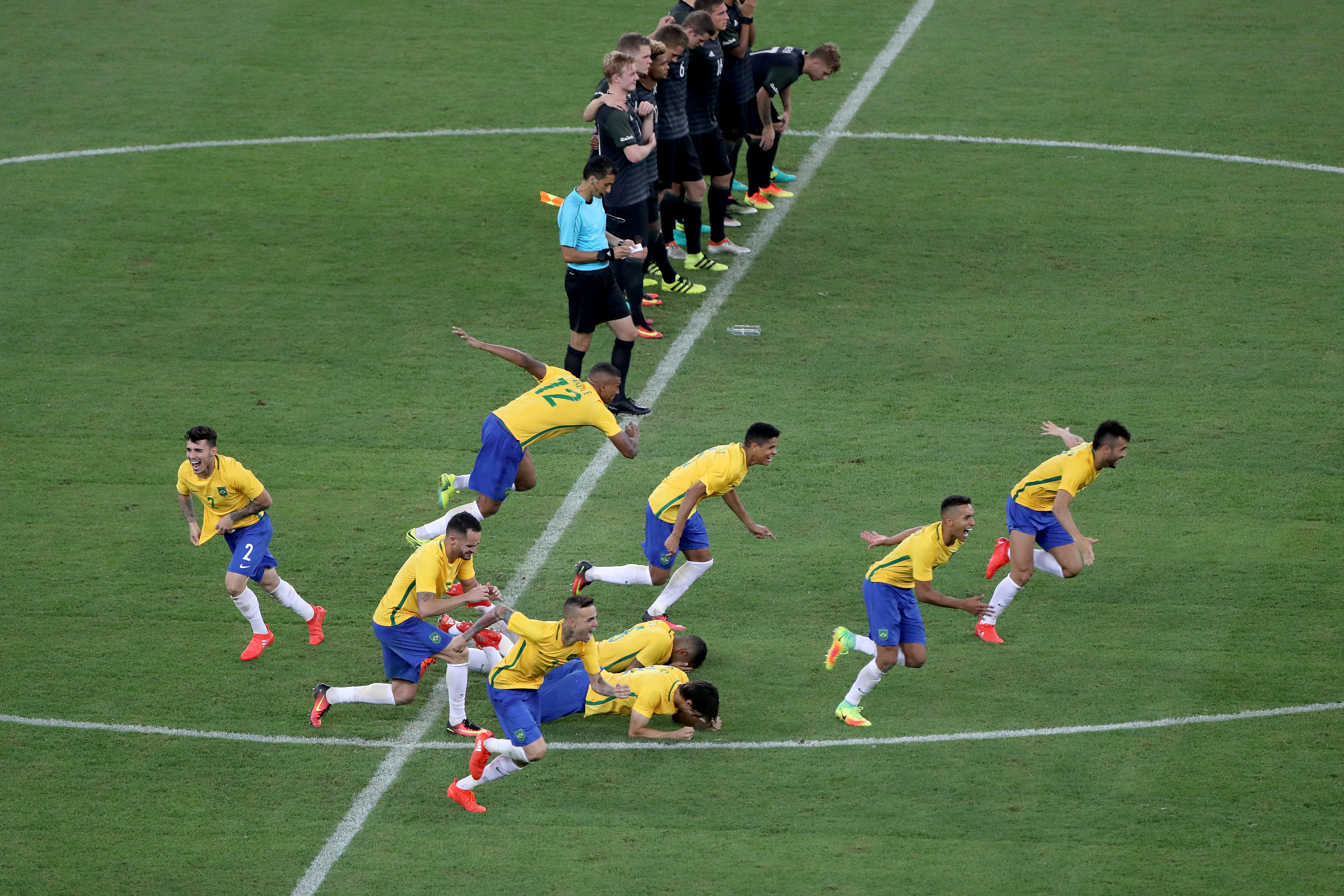 Brazil players celebrate victory against Germany on penalties in the 2016 Olympic men's football final.