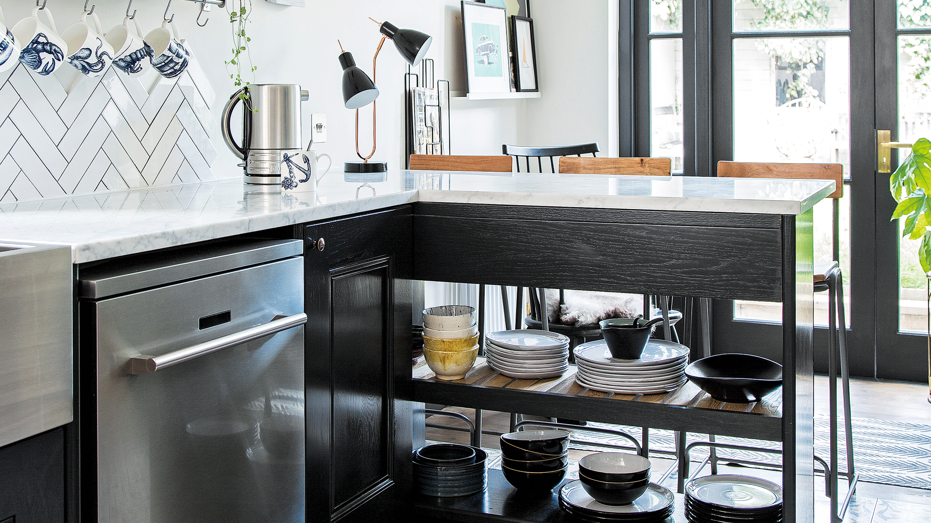 neutral kitchen with wooden table, orange ceiling light and dishwasher