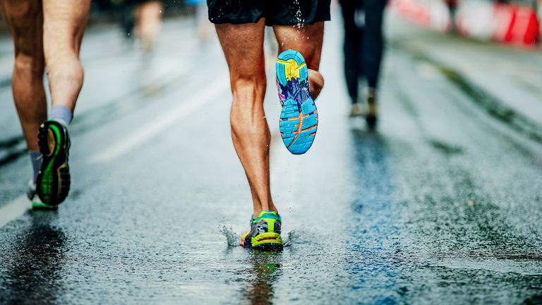 Best waterproof running shoes: Pictured here, water sprays from under running shoes runner men