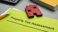 Property tax assessment papers and model of house