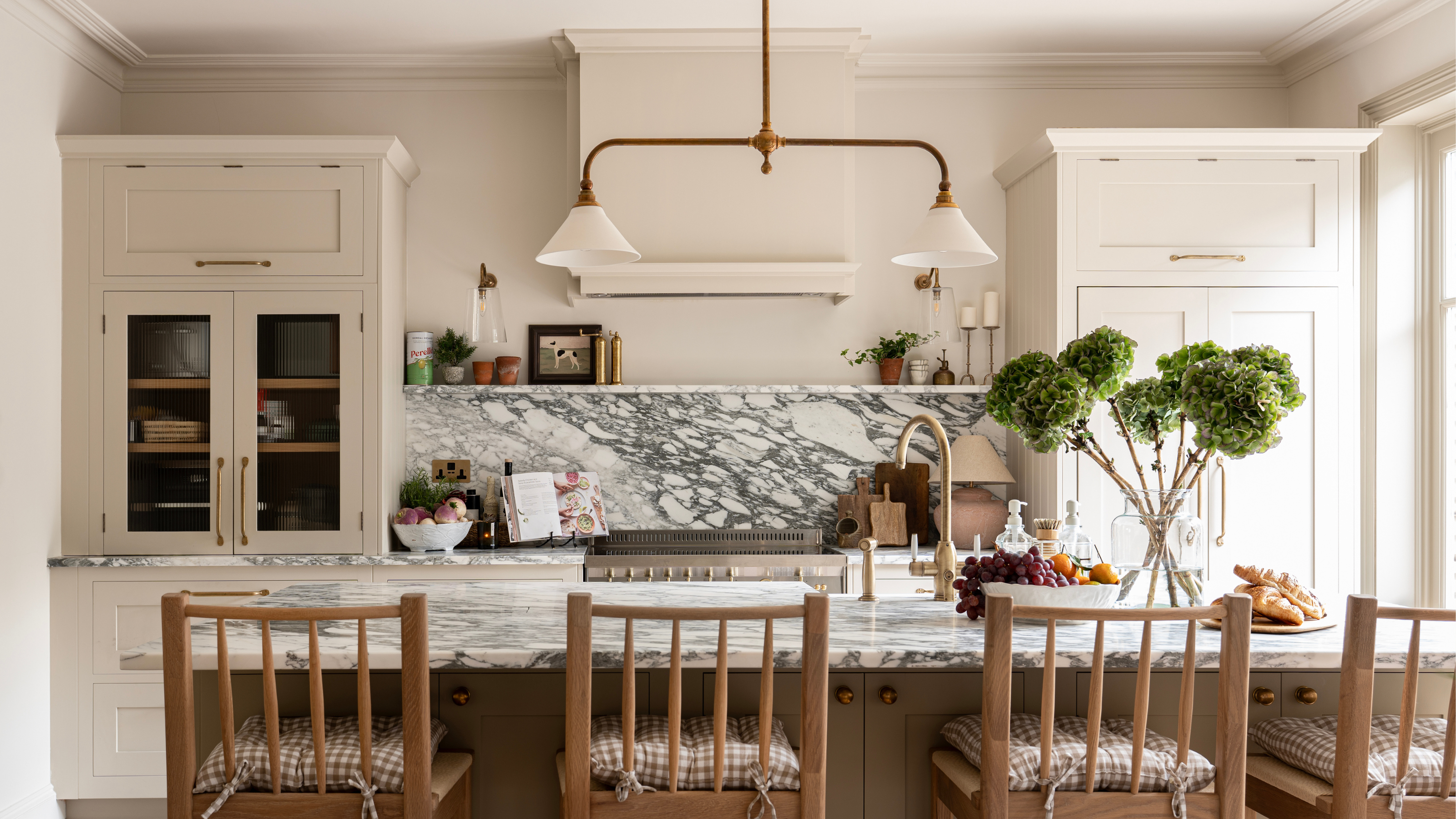 traditional shaker style kitchen with marble island and splashback and white cabinetry