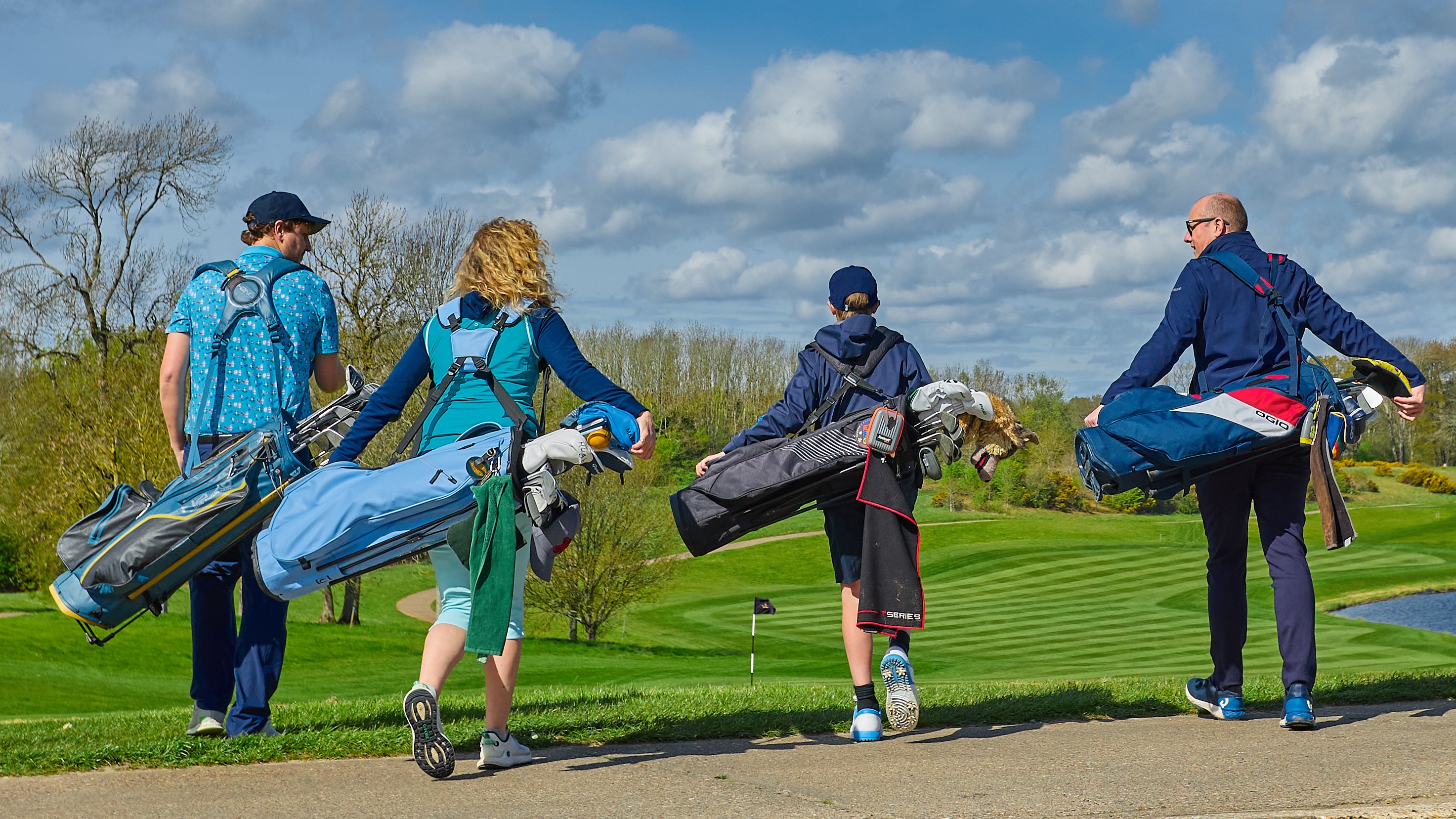 Back view of a fourball walking away from the camera chatting