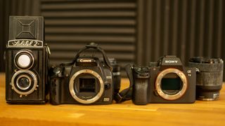 Lubitel 2, Canon DSLR and Sony a7 mirrorless cameras in a row