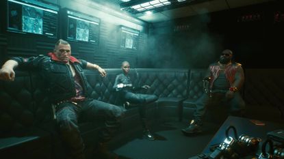 Jackie and Dex sat on a sofa in Cyberpunk 2077.