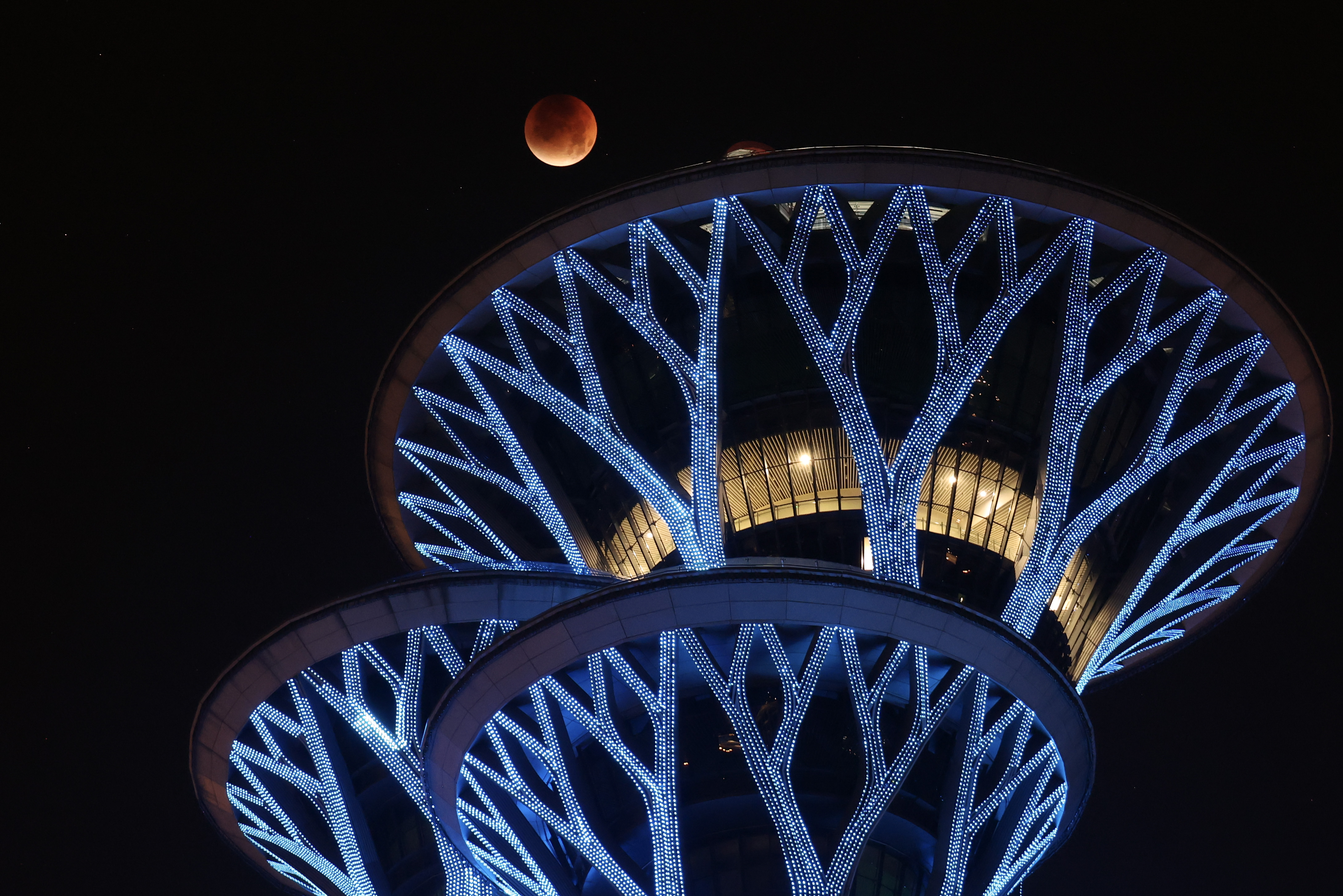 A photograph of the &quot;blood moon&quot; above the Olympic Park Observation Tower in Beijing, China.
