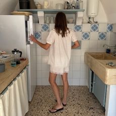 @poppyalmond wearing lace-trim shorts in a kitchen