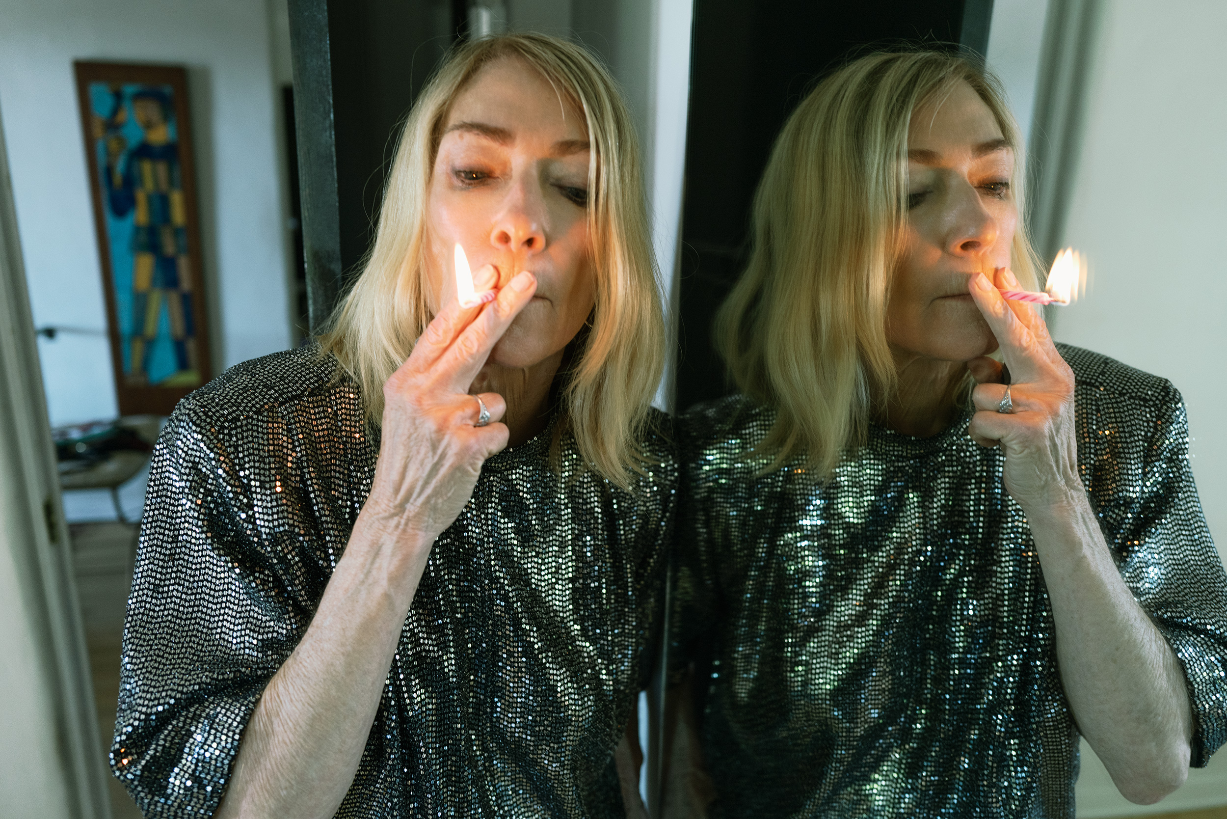 Kim Gordon smoking a birthday candle