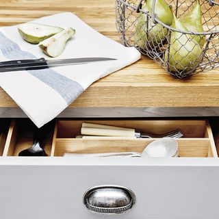 kitchen worktop with drawer and knife with fruit and napkin