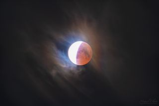 A visible lunar corona surrounds the "blood moon" eclipse of July 27, 2018, in this image captured in Campinho in Portugal's Dark Sky Alqueva Reserve.