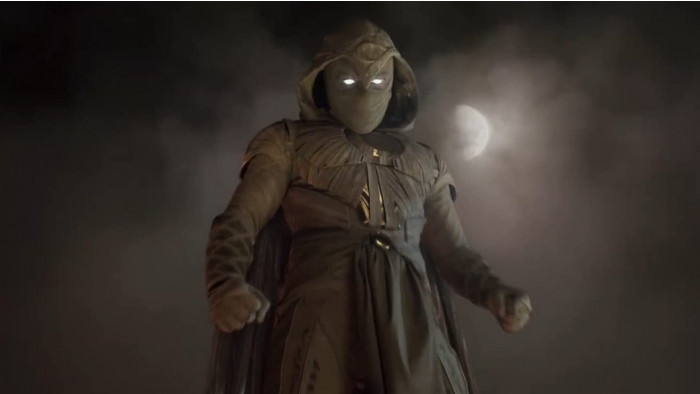 Moon Knight standing with the moon behind him