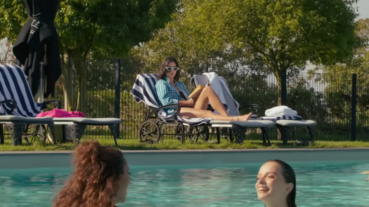 Cassandra Naud as CW lounging at a pool in Influencers