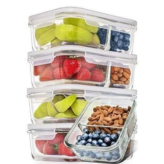 Five glass containers with locking lids stand on top of each other, filled with food