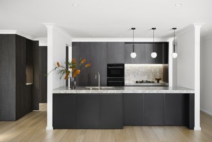 A kitchen with island lighting 