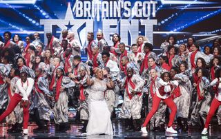 "You have just blown the roof off," Alesha Dixon told The 100 Voices of Gospel… And she smacked the Golden Buzzer just ahead of Simon.