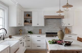 White kitchen with earth tone finishes