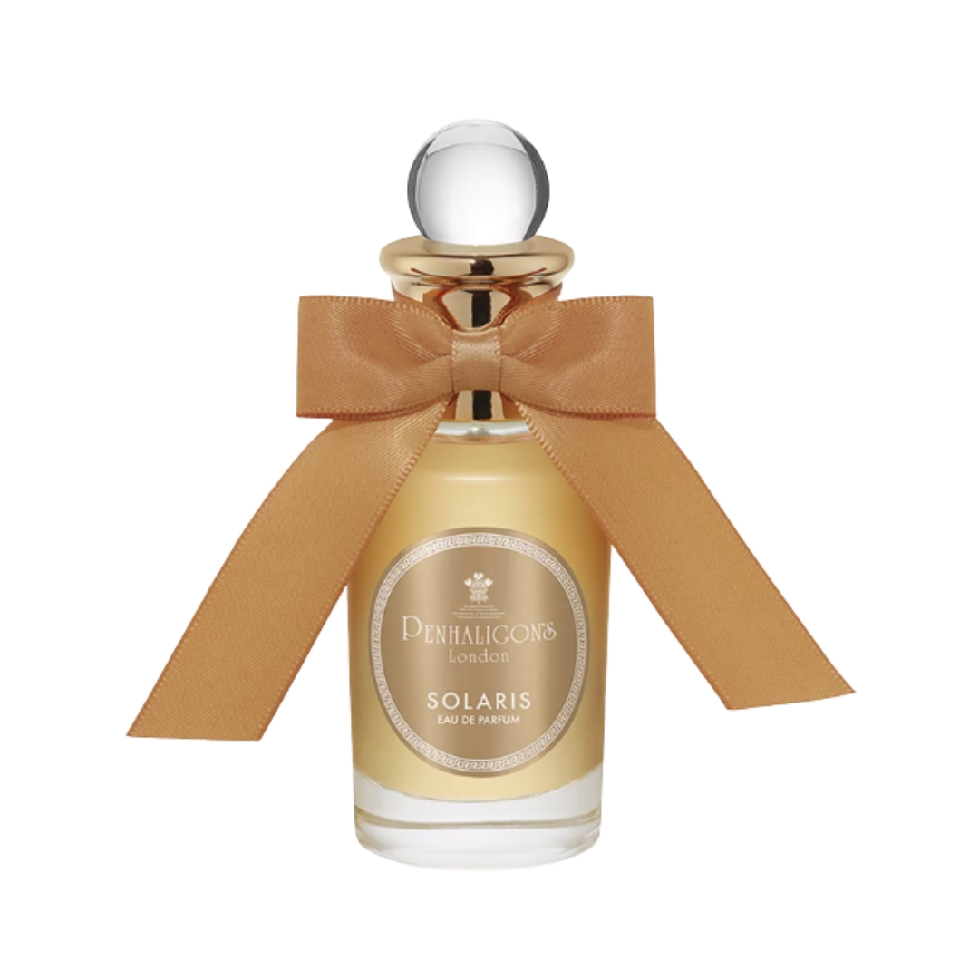 A product shot of the PENHALIGON'S Solaris Eau de Parfum, which features an orange bow around the lid of the bottle, on a white background
