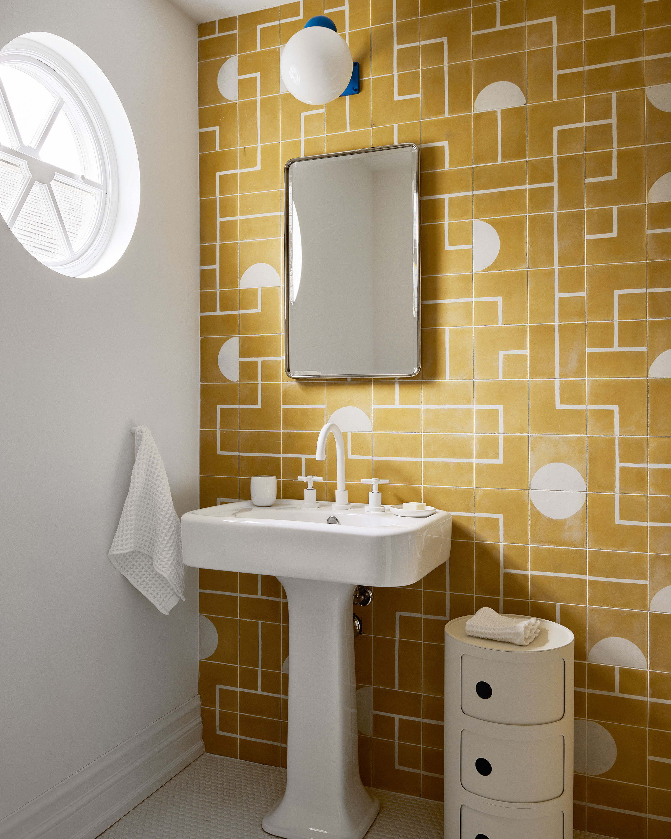 White bathroom with graphic mustard yellow tiles